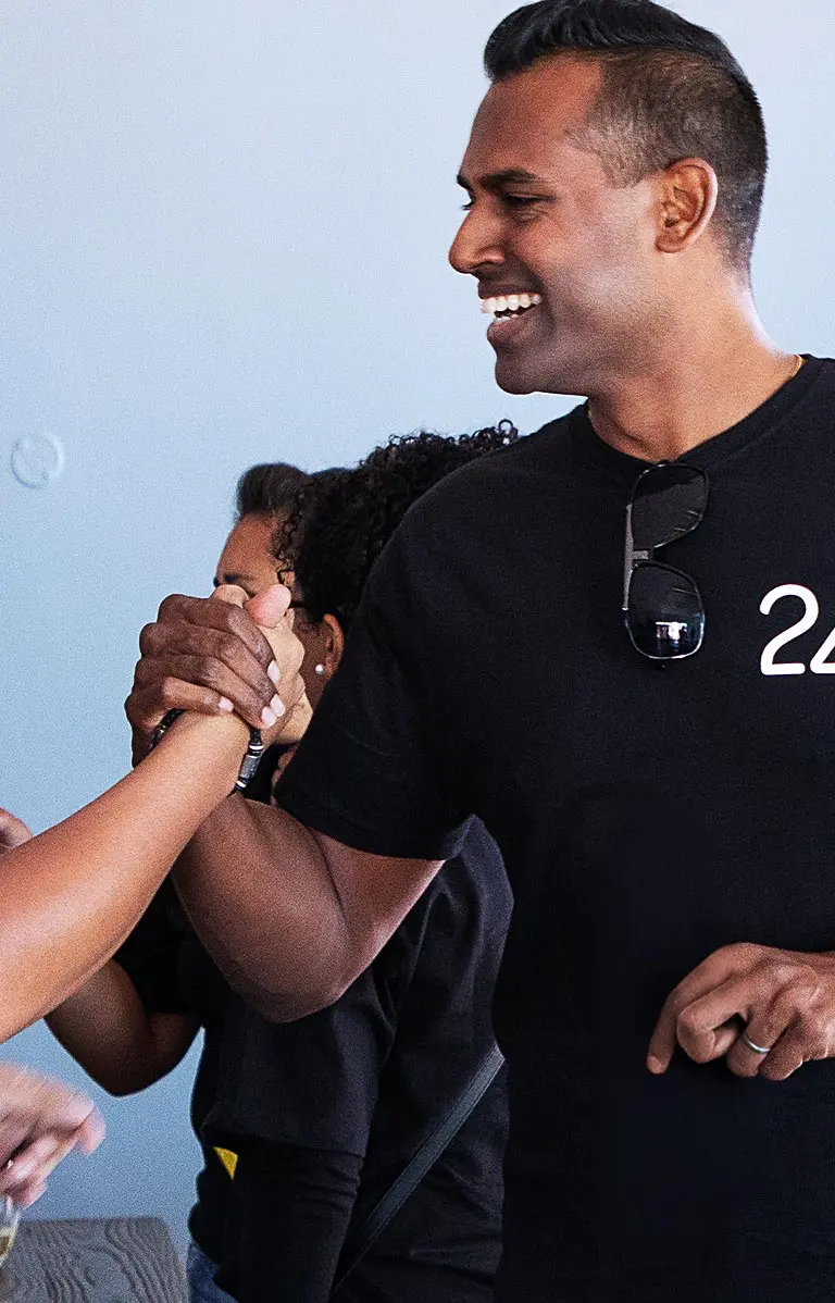 Media24 employees giving a high five